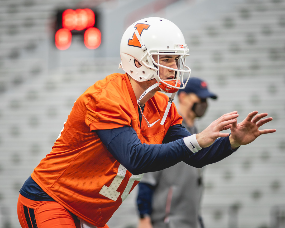 Illinois senior quarterback Brandon Peters taking a snap during the first spring practice on March 23, 2021. 